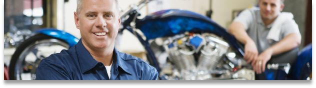 Owner of The Bridge Auto standing in front of his shop in Philadlphia PA